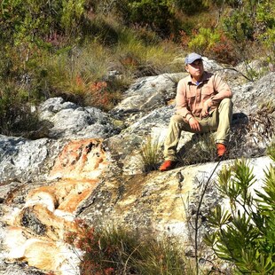 A man sitting on a rock.